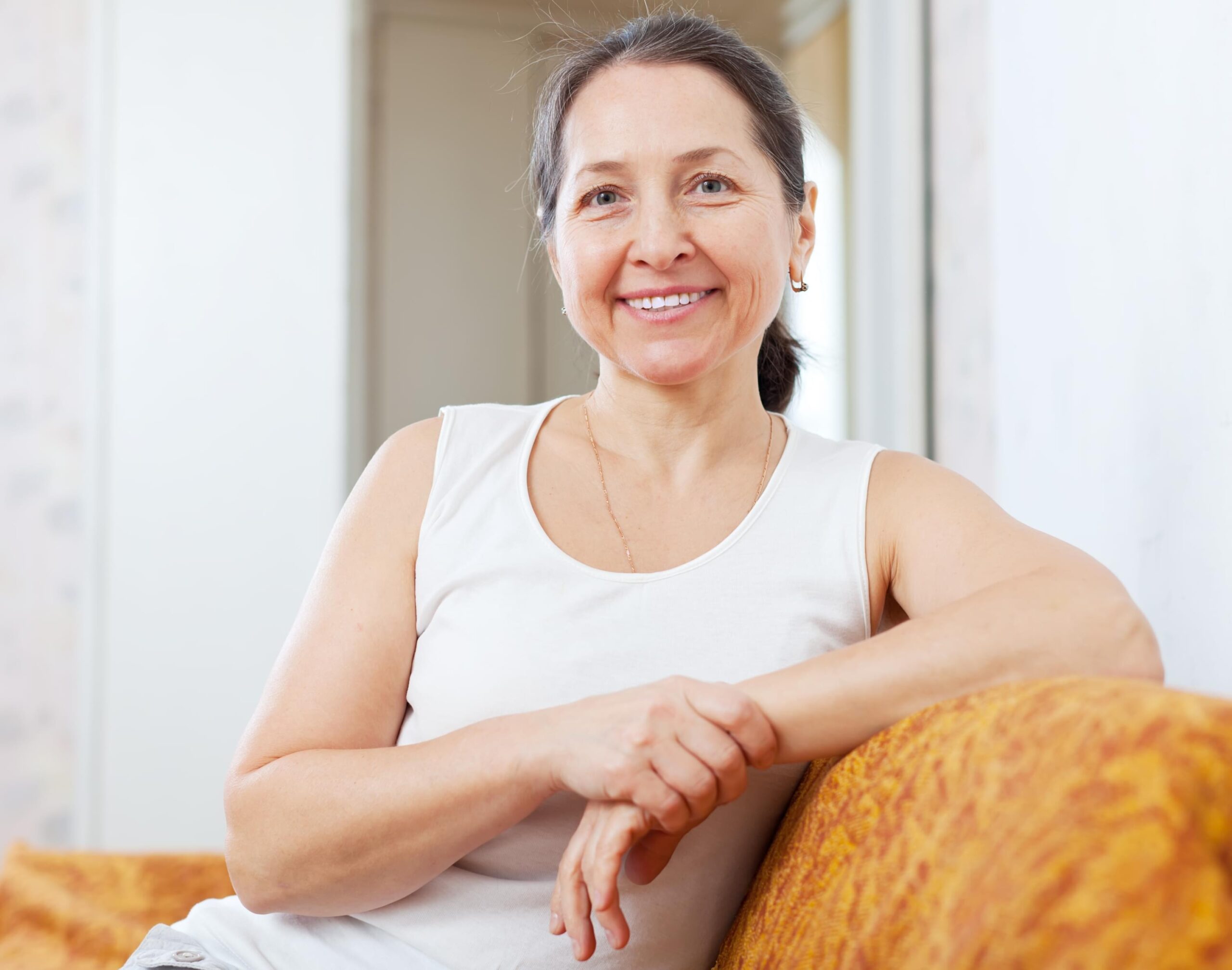 Smiling ordinary mature woman in home interior